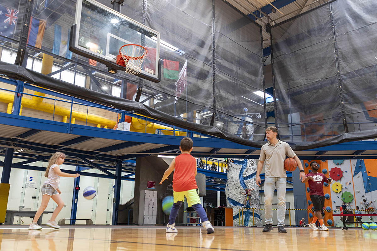 Basketball hoop at the SIU Rec Center with participants shooting baskets