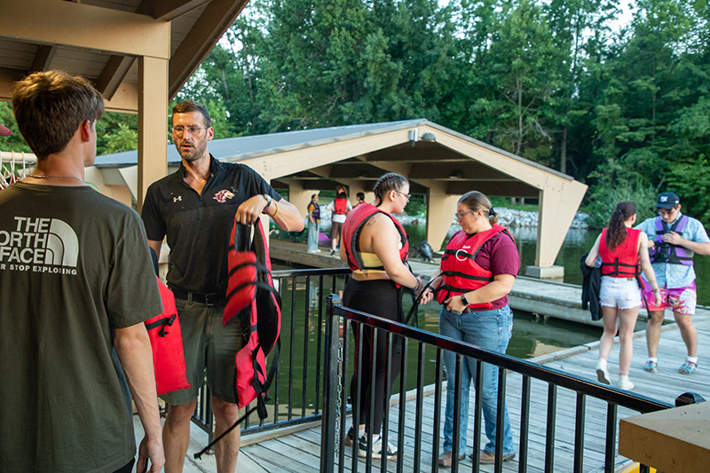 SIU students gather together under Becker Pavilion during Late Night at the Lake event