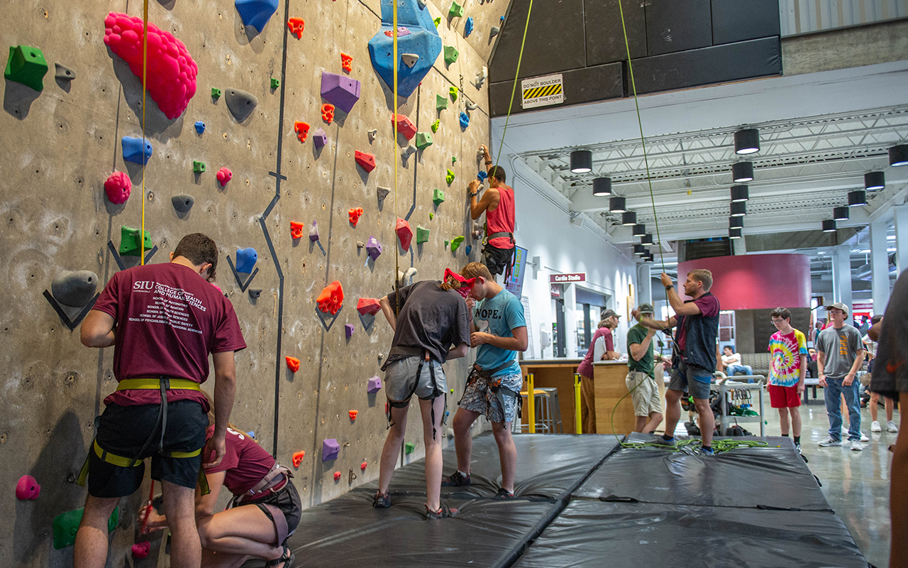 SIU students climb on the climbing wall at the Rec Center