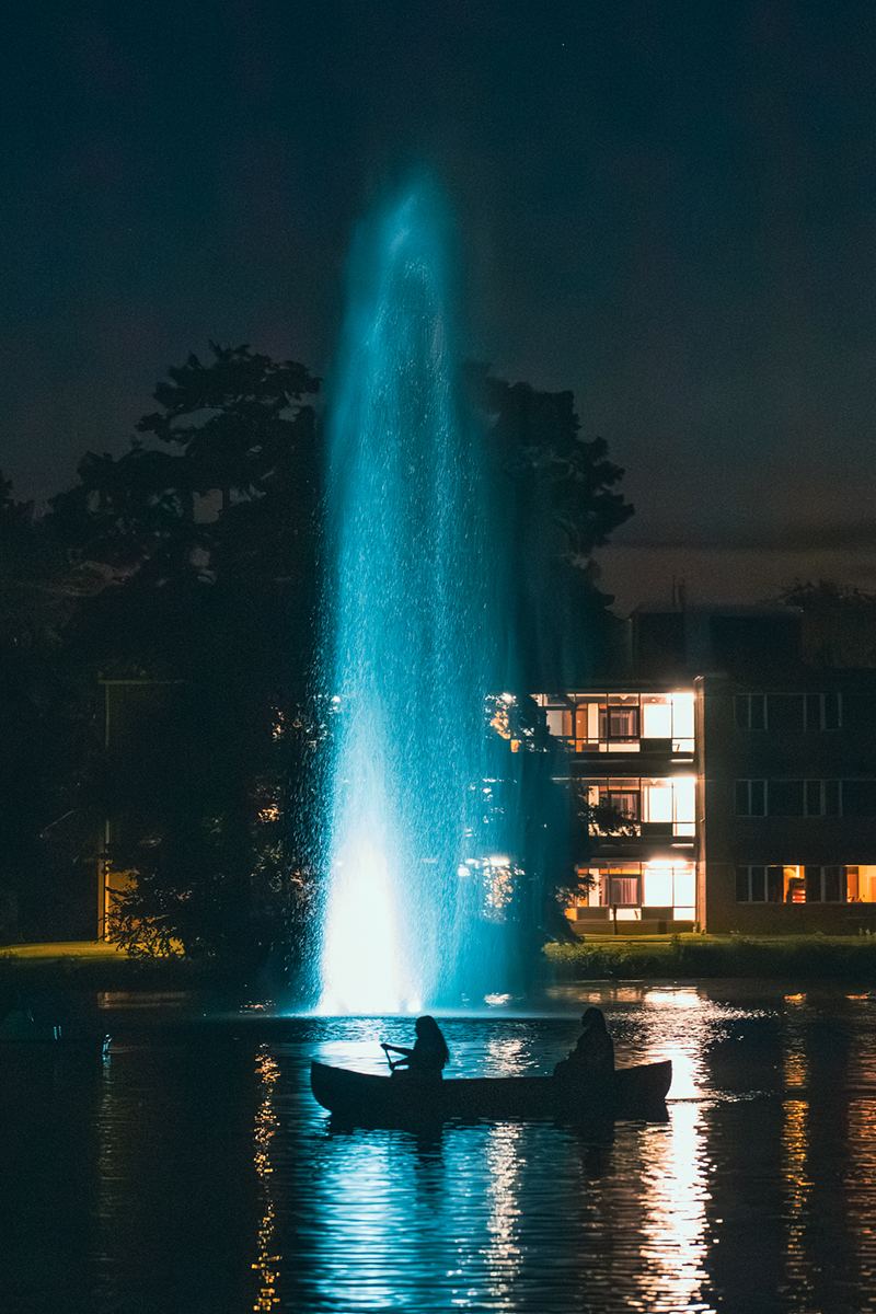 SIU students paddle canoe on Campus Lake at night